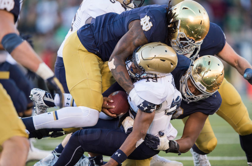 Oct 10, 2015; South Bend, IN, USA; Navy Midshipmen quarterback Keenan Reynolds (19) is tackled by Notre Dame Fighting Irish linebacker Jaylon Smith (9) in the third quarter at Notre Dame Stadium. Mandatory Credit: Matt Cashore-USA TODAY Sports