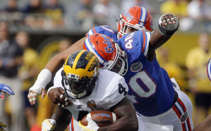 Jan 1, 2016; Orlando, FL, USA; Florida Gators linebacker Jarrad Davis (40) tackles Michigan Wolverines running back De'Veon Smith (4) during the second quarter in the 2016 Citrus Bowl at Orlando Citrus Bowl Stadium. Mandatory Credit: Reinhold Matay-USA TODAY Sports