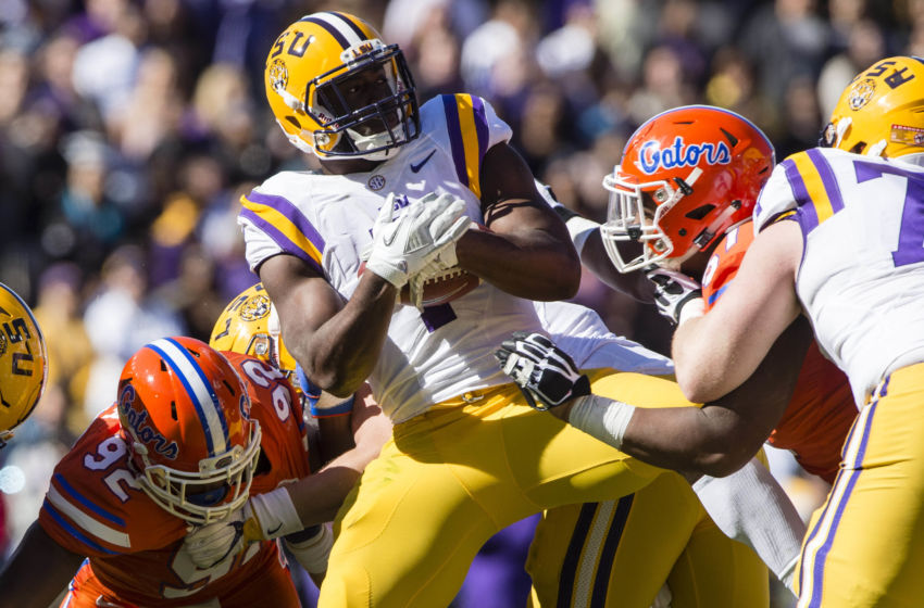Nov 19, 2016; Baton Rouge, LA, USA; LSU Tigers running back Leonard Fournette (7) is brought down by the Florida Gators defense during the first half at Tiger Stadium. Mandatory Credit: Jerome Miron-USA TODAY Sports