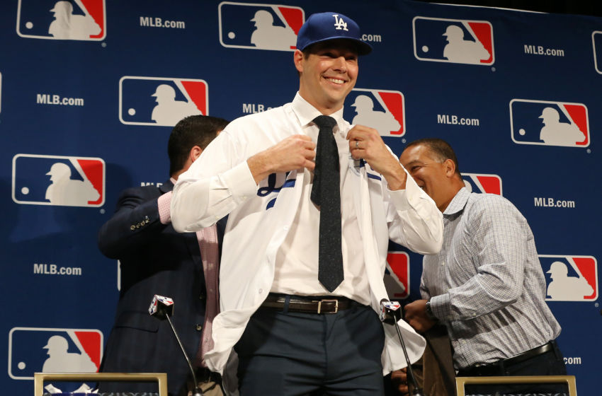 Dec 5, 2016; National Harbor, MD, USA; Los Angeles Dodgers pitcher Rich Hill puts on a Dodgers jersey at a press conference announcing Hill's signing a three year contract during the 2016 MLB Winter Meetings at Gaylord National Resort & Convention Center. Mandatory Credit: Geoff Burke-USA TODAY Sports