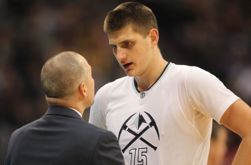 Dec 15, 2016; Denver, CO, USA; Denver Nuggets head coach Michael Malone (left) talks with Denver Nuggets forward Nikola Jokic (15) during the first half at Pepsi Center. The Nuggets won 132-120. Mandatory Credit: Chris Humphreys-USA TODAY Sports