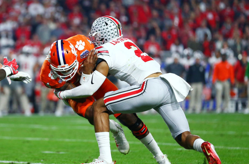 December 31, 2016; Glendale, AZ, USA; Ohio State Buckeyes cornerback Marshon Lattimore (2) tackles Clemson Tigers quarterback Deshaun Watson (4) in the 2016 CFP semifinal at University of Phoenix Stadium. Mandatory Credit: Mark J. Rebilas-USA TODAY Sports