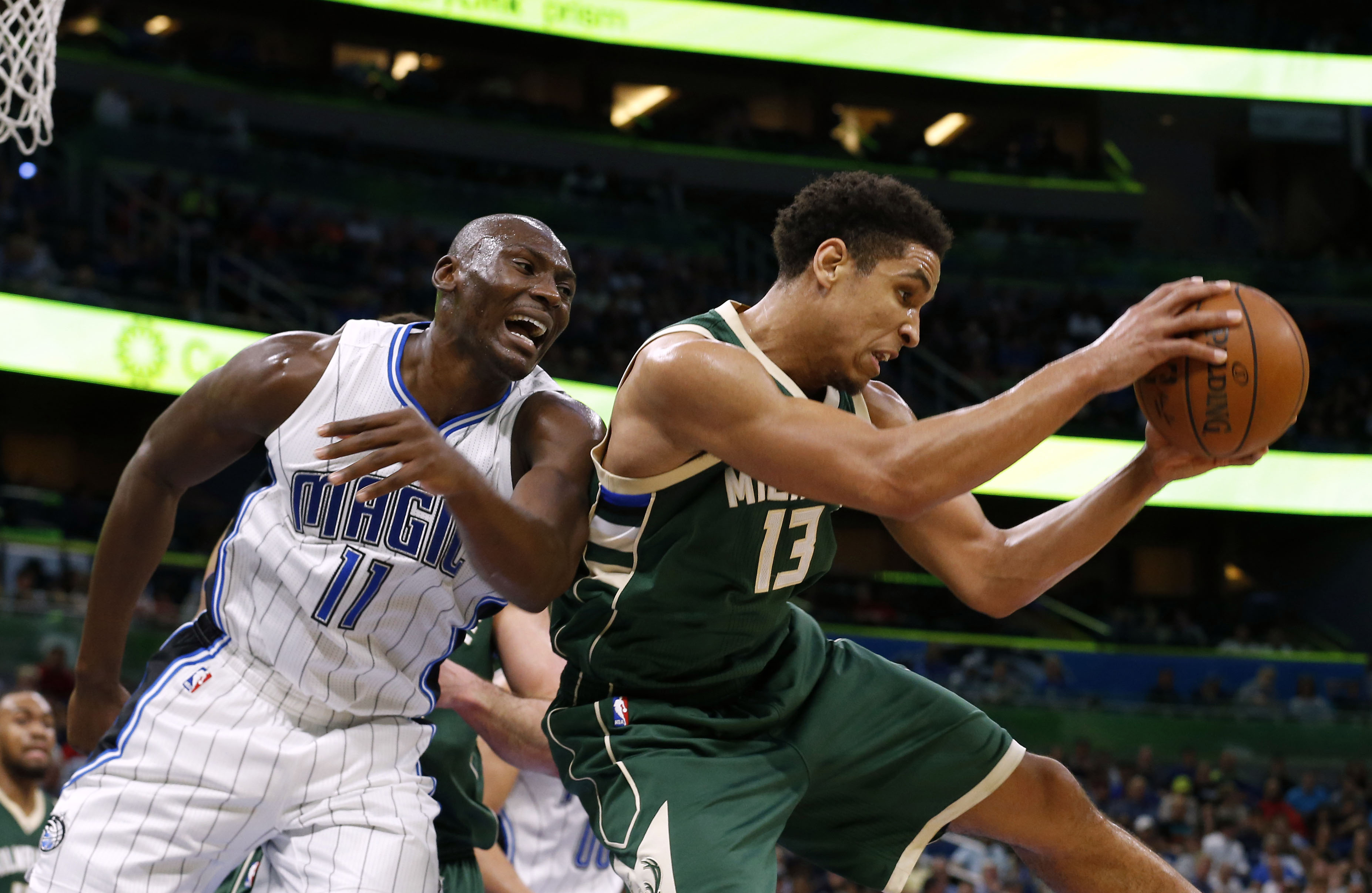 Jan 20, 2017; Orlando, FL, USA;Milwaukee Bucks guard Malcolm Brogdon (13) grabs a rebound from Orlando Magic center Bismack Biyombo (11) during the second half at Amway Center. Orlando Magic defeated the Milwaukee Bucks 112-96. Mandatory Credit: Kim Klement-USA TODAY Sports