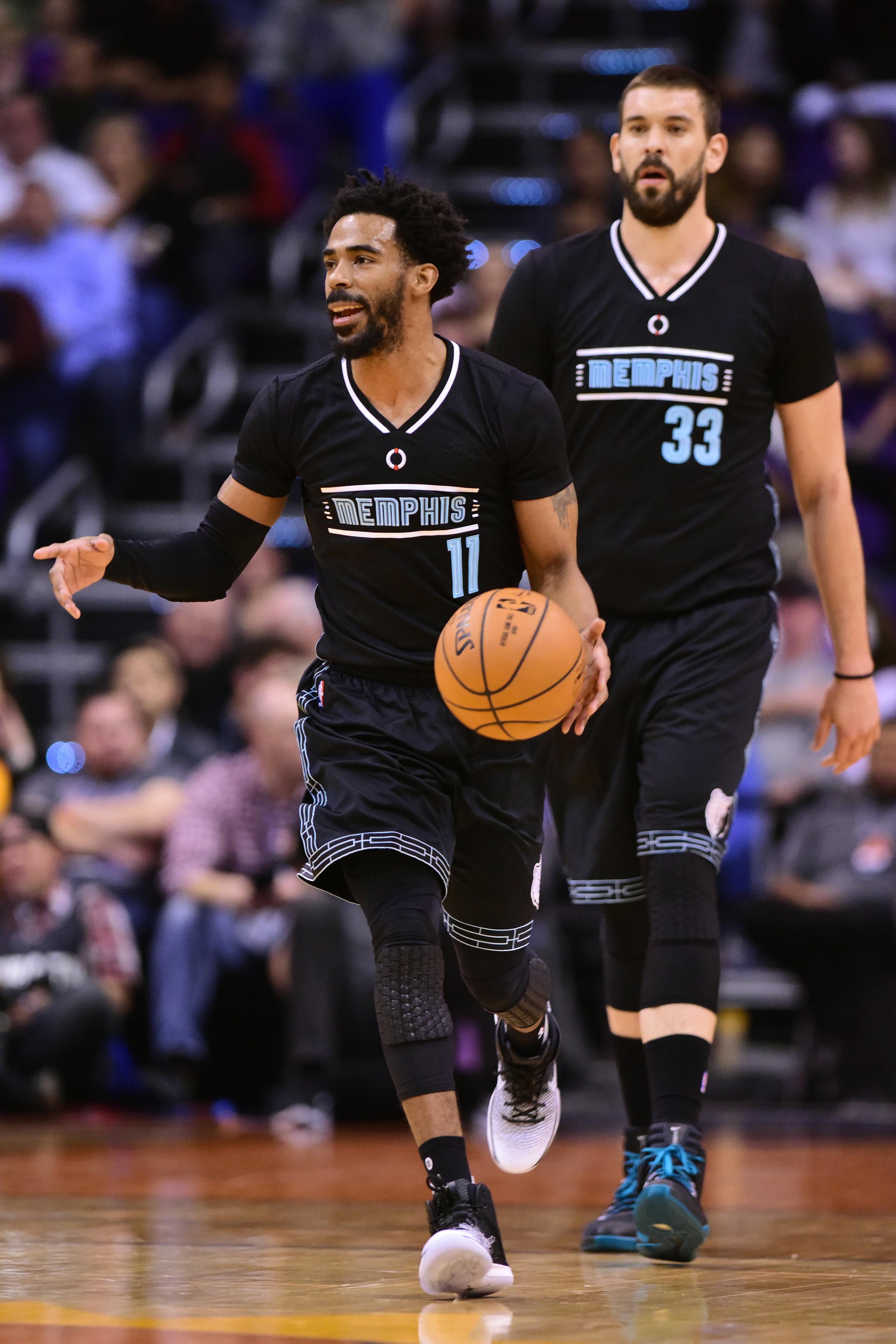 Jan 30, 2017; Phoenix, AZ, USA; Memphis Grizzlies guard Mike Conley (11) dribbles the ball up the court with center Marc Gasol (33) in the first half of the NBA game against the Phoenix Suns at Talking Stick Resort Arena. Mandatory Credit: Jennifer Stewart-USA TODAY Sports