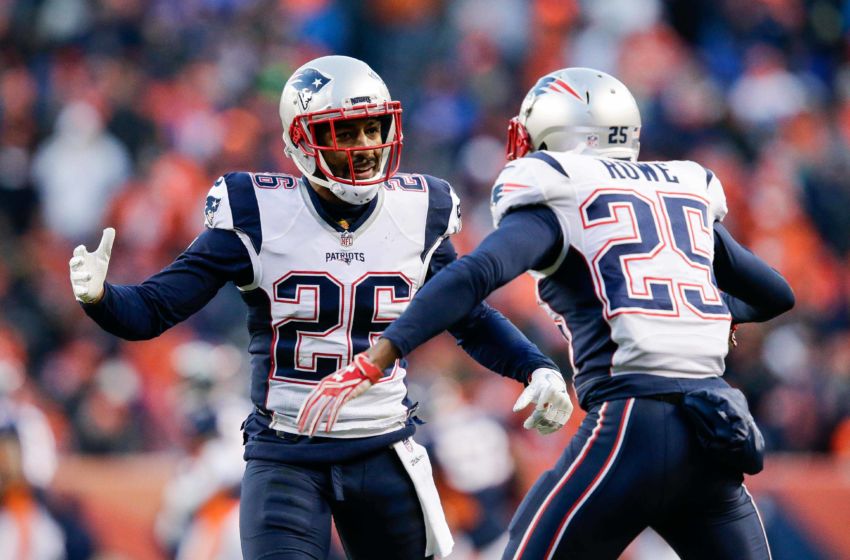 Dec 18, 2016; Denver, CO, USA; New England Patriots cornerback Logan Ryan (26) celebrates with defensive back Eric Rowe (25) after a play in the third quarter against the Denver Broncos at Sports Authority Field at Mile High. Mandatory Credit: Isaiah J. Downing-USA TODAY Sports