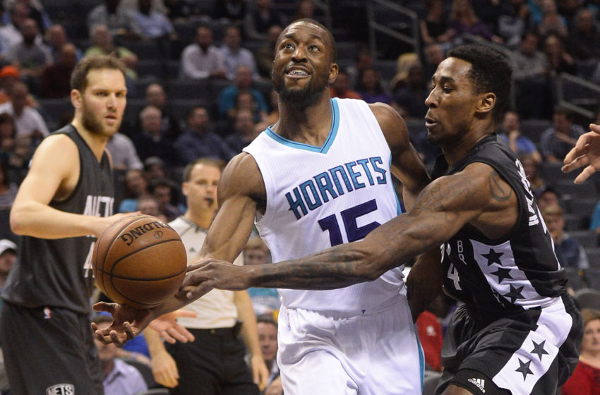 Feb 7, 2017; Charlotte, NC, USA; Charlotte Hornets guard Kemba Walker (15) is fouled by Brooklyn Nets forward Rondae Hollis-Jefferson (24) during the first half of the game at the Spectrum Center. Mandatory Credit: Sam Sharpe-USA TODAY Sports