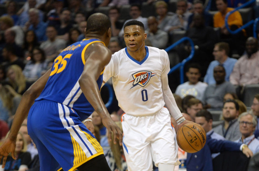 Feb 11, 2017; Oklahoma City, OK, USA; Oklahoma City Thunder guard Russell Westbrook (0) handles the ball in front of Golden State Warriors forward Kevin Durant (35) during the fourth quarter at Chesapeake Energy Arena. Mandatory Credit: Mark D. Smith-USA TODAY Sports