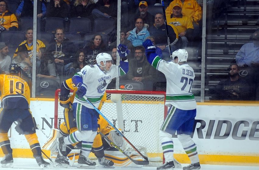 Mar 24, 2016; Nashville, TN, USA; Vancouver Canucks left winger Daniel Sedin (22) and left winger Alex Burrows (14) celebrate after a goal during the first period against the Nashville Predators at Bridgestone Arena. Mandatory Credit: Christopher Hanewinckel-USA TODAY Sports