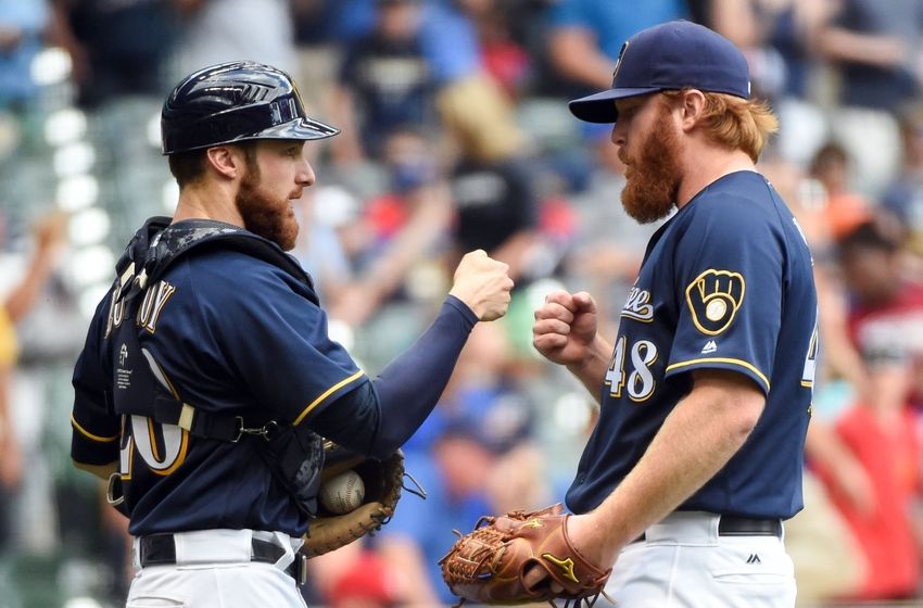 May 29, 2016; Milwaukee, WI, USA; Milwaukee Brewers catcher Jonathan Lucroy (20) and pitcher <a rel=