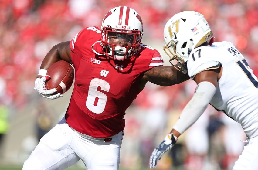 Sep 10, 2016; Madison, WI, USA; Wisconsin Badgers running back Corey Clement (6) stiff arms Akron Zips defensive back Bryce Jones (17) during the game against the Akron Zips at Camp Randall Stadium. Wisconsin defeated Akron 54-10. Mandatory Credit: Mary Langenfeld-USA TODAY Sports