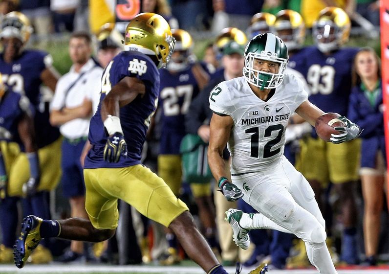 Sep 17, 2016; South Bend, IN, USA; Michigan State Spartans wide receiver R.J. Shelton (12) runs the ball against Notre Dame Fighting Irish defensive back Nick Coleman (24) during the second half a game at Notre Dame Stadium. Mandatory Credit: Mike Carter-USA TODAY Sports