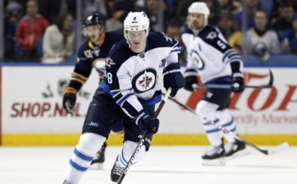 Nov 26, 2014; Buffalo, NY, USA; Winnipeg Jets defenseman Jacob Trouba (8) heads into the Buffalo Sabres zone during the third period at First Niagara Center. Jets beat the Sabres 2-1. Mandatory Credit: Kevin Hoffman-USA TODAY Sports