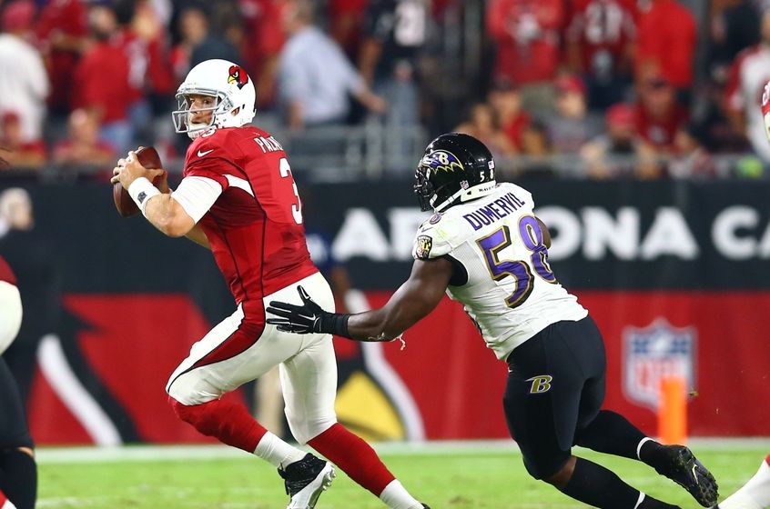 Oct 26, 2015; Glendale, AZ, USA; Baltimore Ravens linebacker Elvis Dumervil (58) pursues Arizona Cardinals quarterback Carson Palmer (3) at University of Phoenix Stadium. The Cardinals defeated the Ravens 26-18. Mandatory Credit: Mark J. Rebilas-USA TODAY Sports