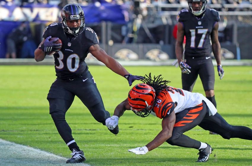 Nov 27, 2016; Baltimore, MD, USA; Baltimore Ravens running back Kenneth Dixon (30) is forced out of bounds on a run by Cincinnati Bengals cornerback Josh Shaw (26) at M&T Bank Stadium. Mandatory Credit: Mitch Stringer-USA TODAY Sports