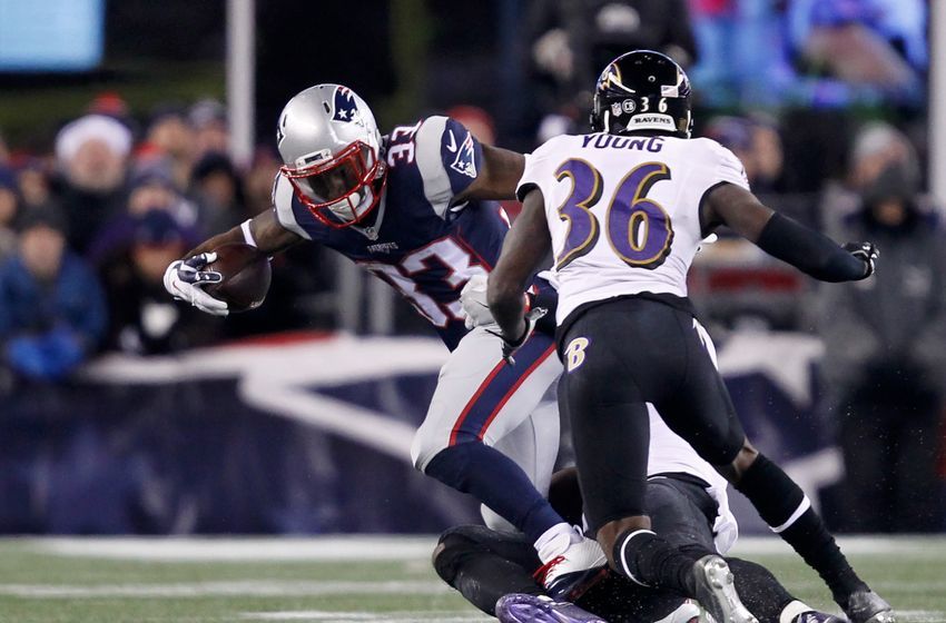 Dec 12, 2016; Foxborough, MA, USA; New England Patriots running back Dion Lewis (33) rushes against Baltimore Ravens cornerback Tavon Young (36) during the second half at Gillette Stadium. Mandatory Credit: Stew Milne-USA TODAY Sports 