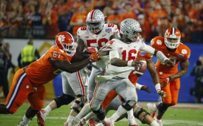 Dec 31, 2016; Phoenix, AZ, USA; Clemson Tigers defensive tackle Albert Huggins (67) grabs the jersey of Ohio State Buckeyes quarterback J.T. Barrett (16) as he scrambles during the fourth quarter during the 2016 CFP semifinal at University of Phoenix Stadium. Mandatory Credit: David Kadlubowski/The Arizona Republic via USA TODAY Sports