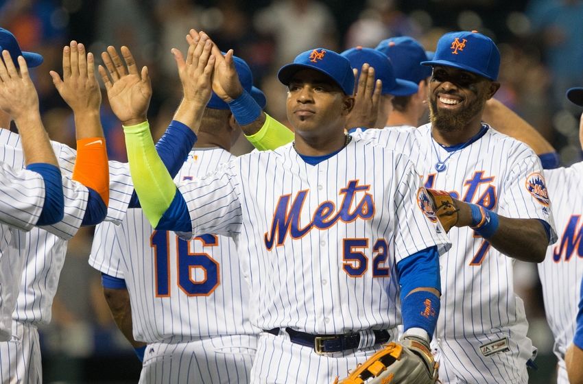 Sep 23, 2016; New York City, NY, USA; New York Mets left fielder Yoenis Cespedes (52) and third baseman Jose Reyes (7) lead the high five line after a victory against the Philadelphia Phillies at Citi Field. The won 10-5. Mandatory Credit: Bill Streicher-USA TODAY Sports