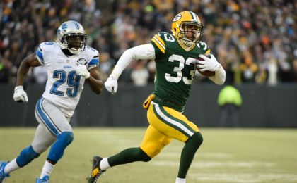 Dec 28, 2014; Green Bay, WI, USA; Green Bay Packers safety Micah Hyde (33) returns a punt 55-yards for a touchdown in the first quarter during the game against the Detroit Lions at Lambeau Field. At left is Detroit Lions cornerback <a rel=