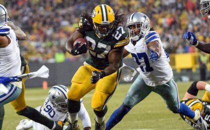 Green Bay Packers running back Eddie Lacy tries to break tackles by Dallas Cowboys defensive end DeMarcus Lawrence (90) and safety <a rel=