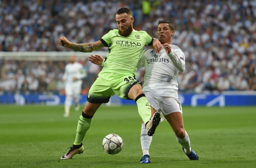 MADRID, ENGLAND - MAY 04: Nicolas Otamendi of Manchester City holds off the challenge from Cristiano Ronaldo of Real Madrid during the UEFA Champions League semi final, second leg match between Real Madrid and Manchester City FC at Estadio Santiago Bernabeu on May 4, 2016 in Madrid, Spain. (Photo by Michael Regan/Getty Images)