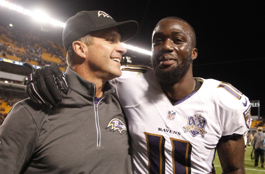 Oct 1, 2015; Pittsburgh, PA, USA; Baltimore Ravens head coach John Harbaugh (L) and wide receiver Kamar Aiken (11) celebrate while leaving the field after defeating the Pittsburgh Steelers at Heinz Field. The Ravens won 23-20 in overtime. Mandatory Credit: Charles LeClaire-USA TODAY Sports