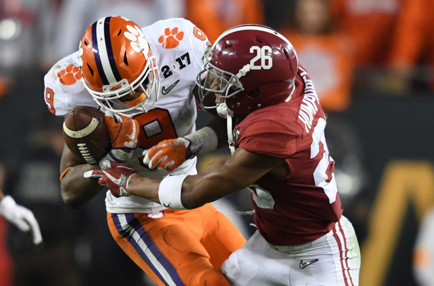 Jan 9, 2017; Tampa, FL, USA; Clemson Tigers running back Wayne Gallman (9) works to control the ball while defended by Alabama Crimson Tide defensive back Marlon Humphrey (26) during the fourth quarter in the 2017 College Football Playoff National Championship Game at Raymond James Stadium. Mandatory Credit: John David Mercer-USA TODAY Sports