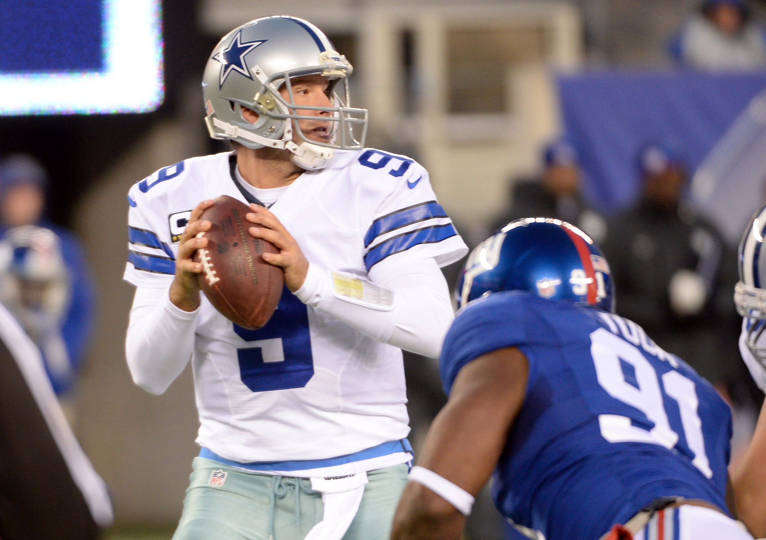 Dallas Cowboys quarterback Tony Romo (9) runs out of the pocket against the  New York Giants in the third quarter in week 1 of the NFL season at MetLife  Stadium in East